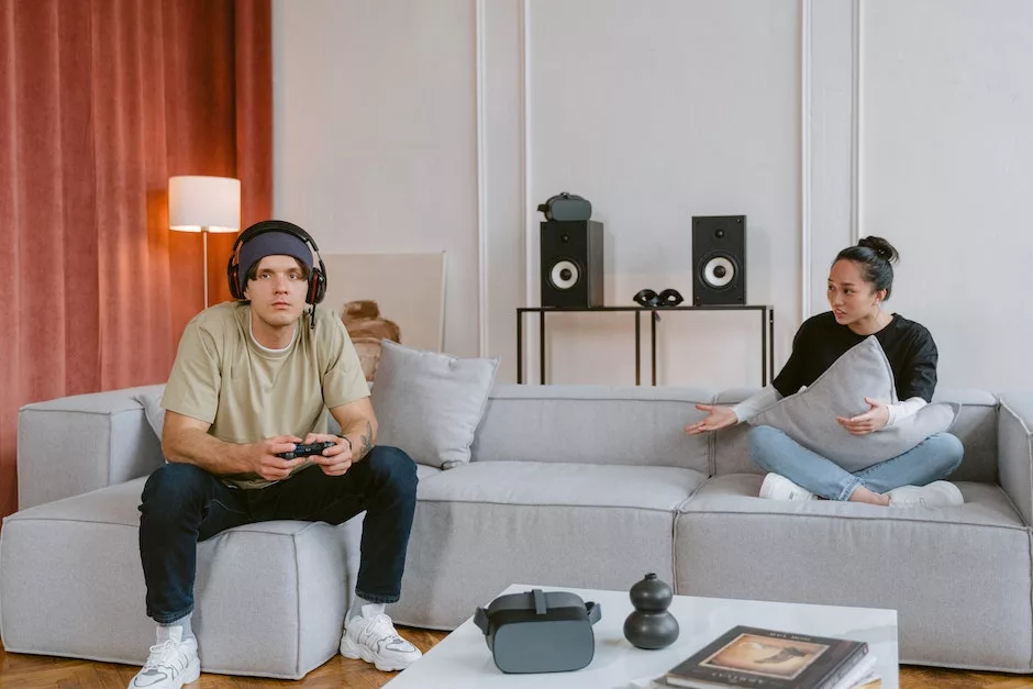 A Man Focus Playing a Video Game Sitting Near a Woman