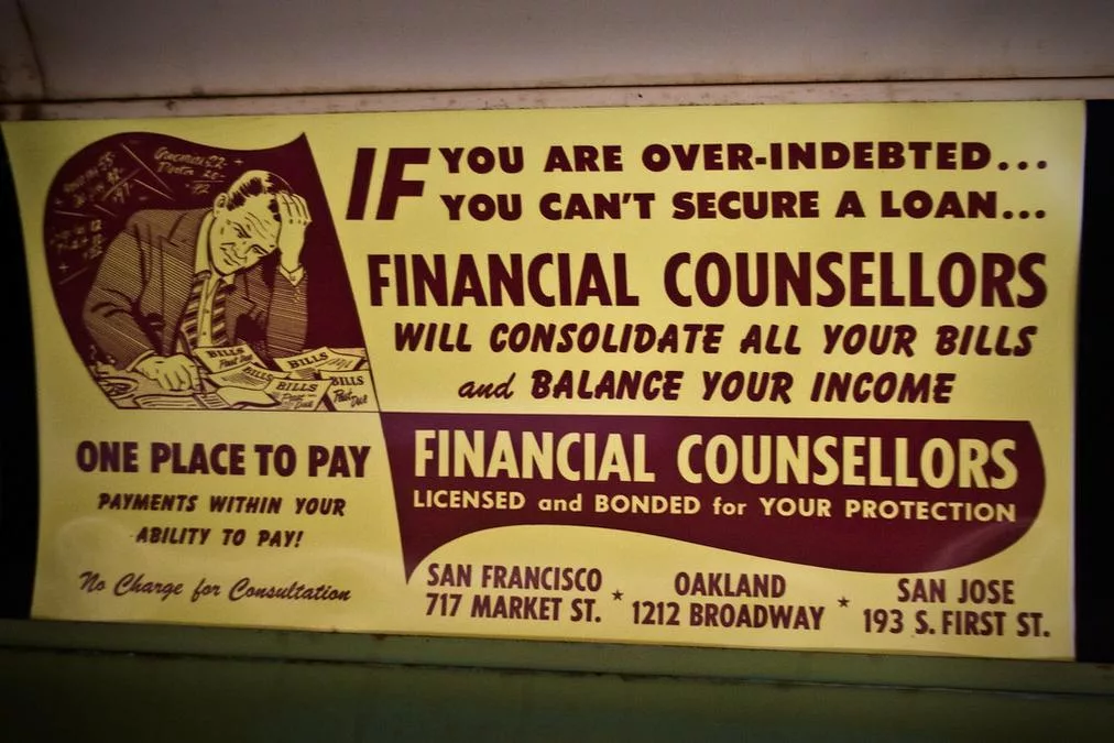 Debt Consolidation, Circa 1948 - a sign on a wall that says financial counselors
