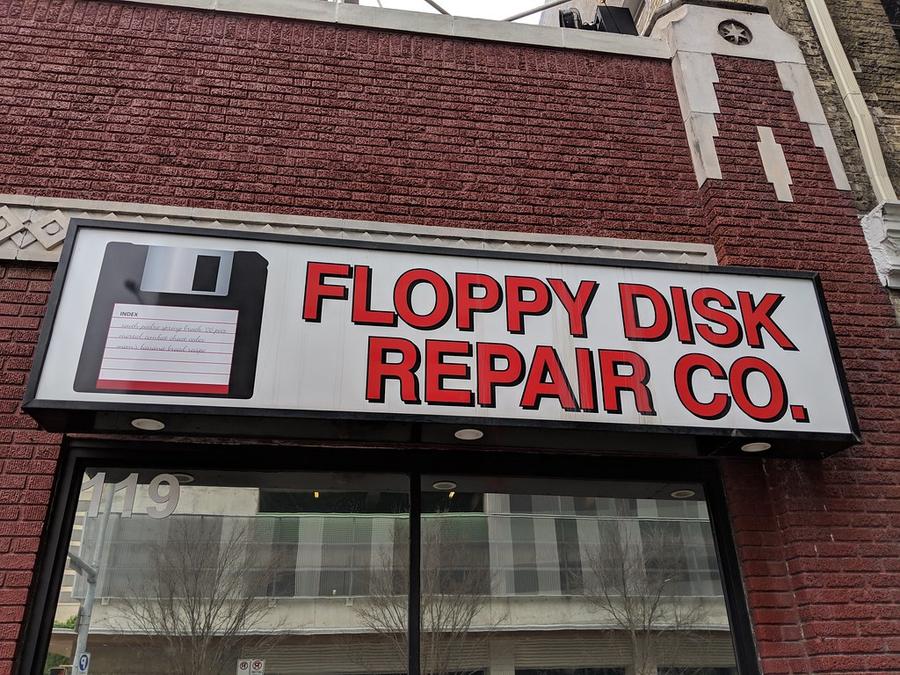 Floppy Disk Repair Company sign, Austin, Texas, USA - a sign that says poppy's repair on the side of
