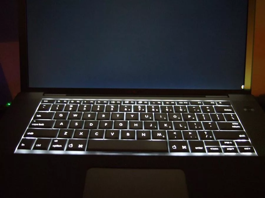 Keyboard Backlight in Dark Room - a laptop with a keyboard on it