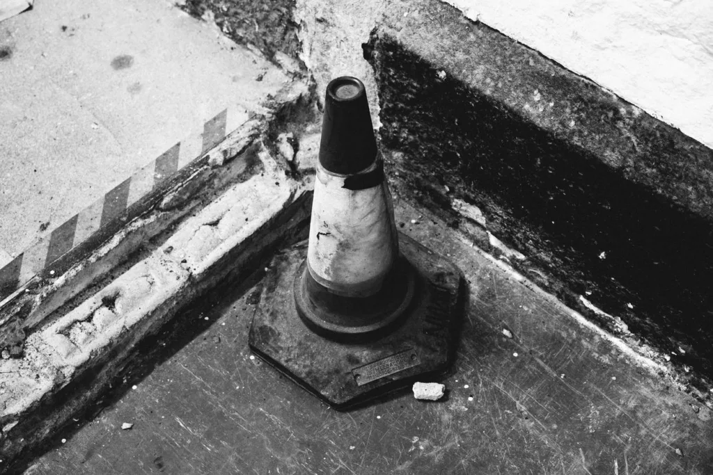 Old street cone, black and - a black and white photo of a street light