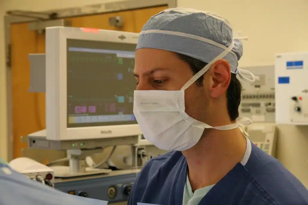 File:CPMC Surgery (412142792).jpg - a man wearing a surgical mask and a surgical gown